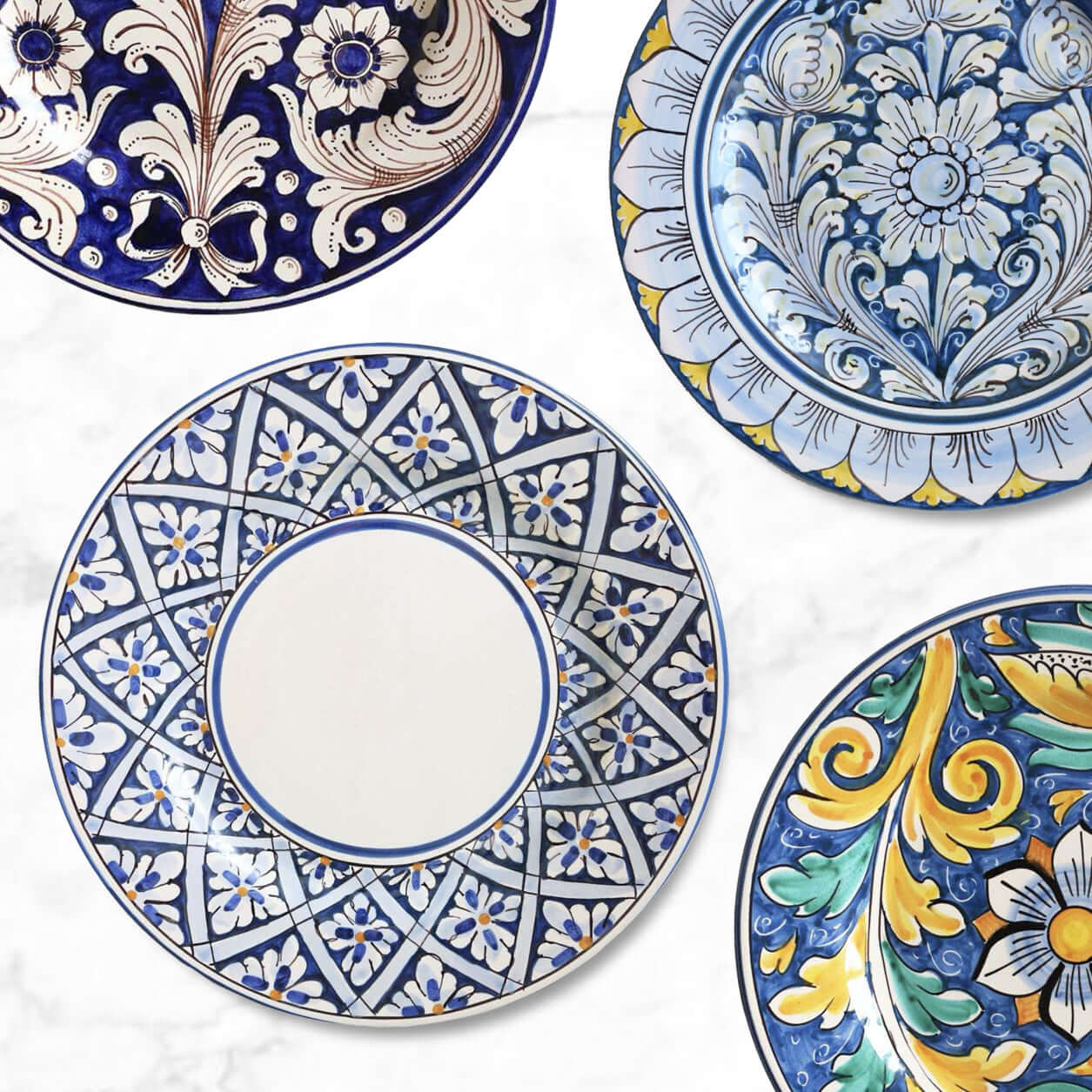 Colorful Sicilian dinner plates displayed on marble table, showcasing mix-and-match designs, handmade ceramic craftsmanship, vibrant patterns and traditional artistry