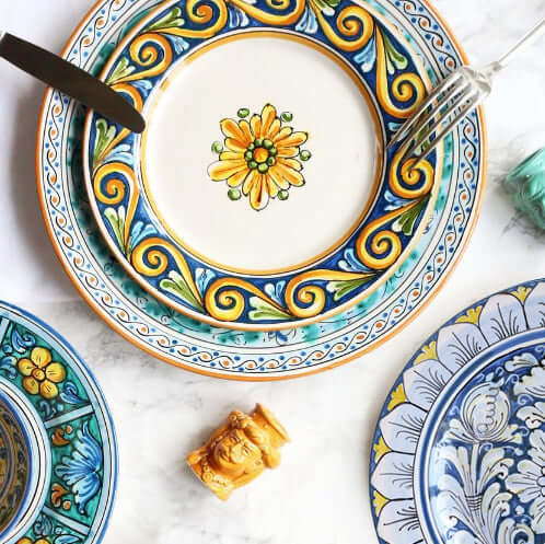 Handcrafted Sicilian ceramic plates with vibrant floral design, set of two. Made in Caltagirone, Sicily, showcasing artisan craftsmanship.