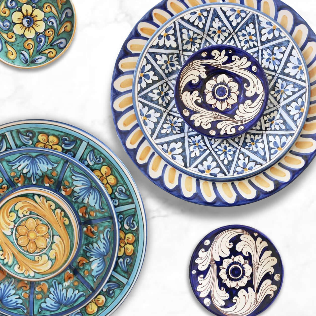 Colorful Sicily plates stacked for a vibrant tablescape, salad and dessert plates on top, dinner plate below, mix and match designs, handmade ceramic craftsmanship